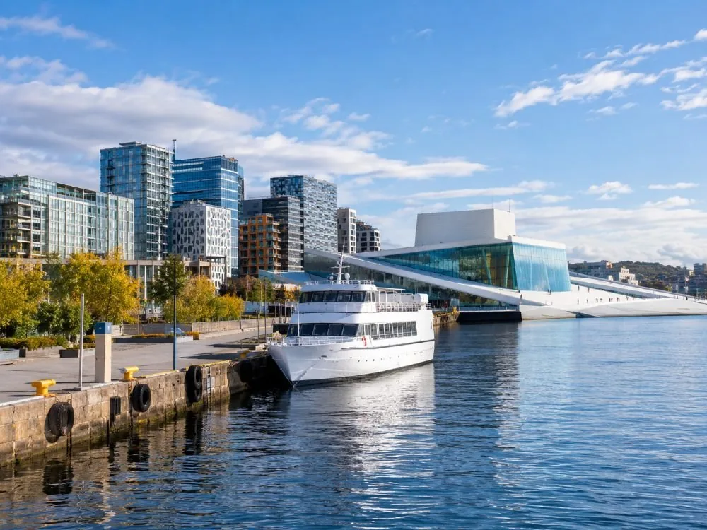 Langkaia, the separate quay on the Bjørvika side near the Opera House and Central Station, with a white passenger ship alongside and the city's newer towers rising behind the waterfront.