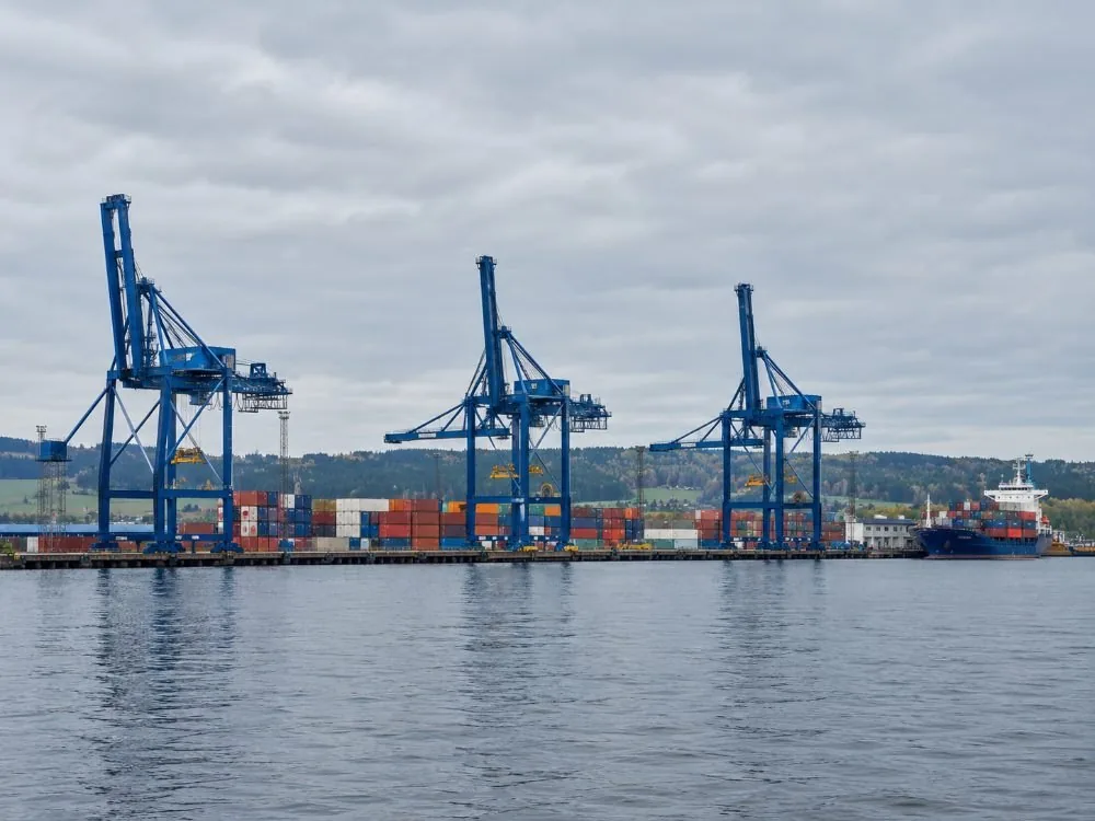 Container cranes and stacked boxes at Sjursøya on the eastern shore of the fjord, the working port that sits in the same water as the sightseeing boats.